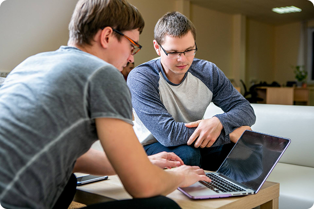 Two colleagues studying together on laptop